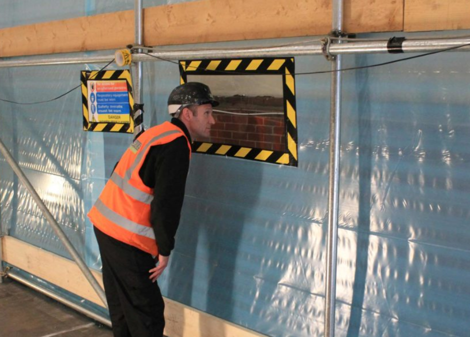 asbestos remediation - man monitoring asbestos